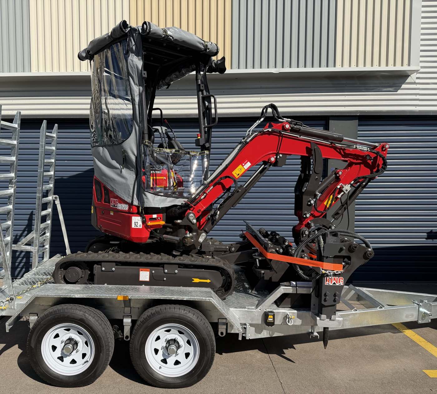 The 2.3 tonne excavator side on, showing the boom, cab canopy and rubber tracks